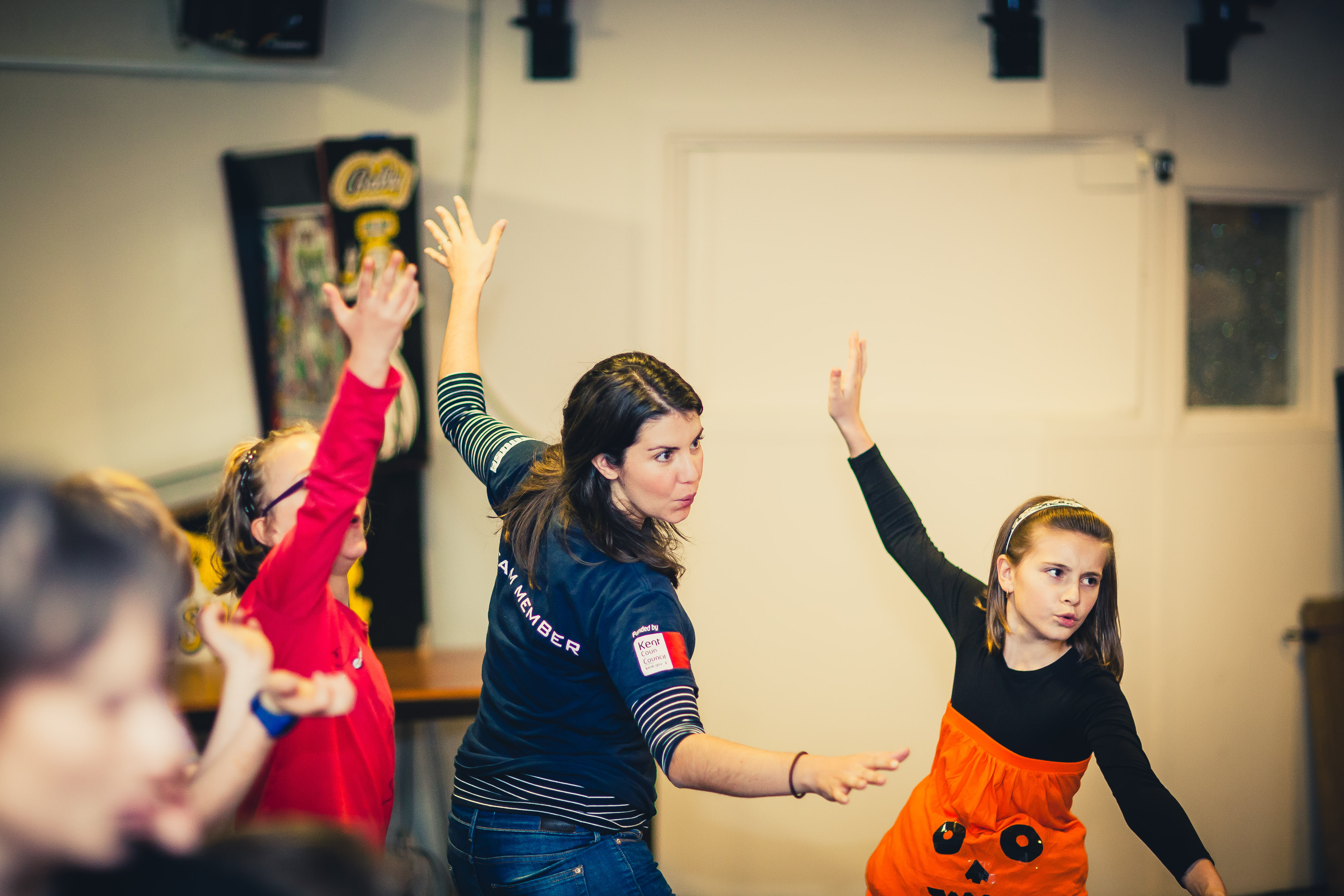 Youth worker dancing with school children