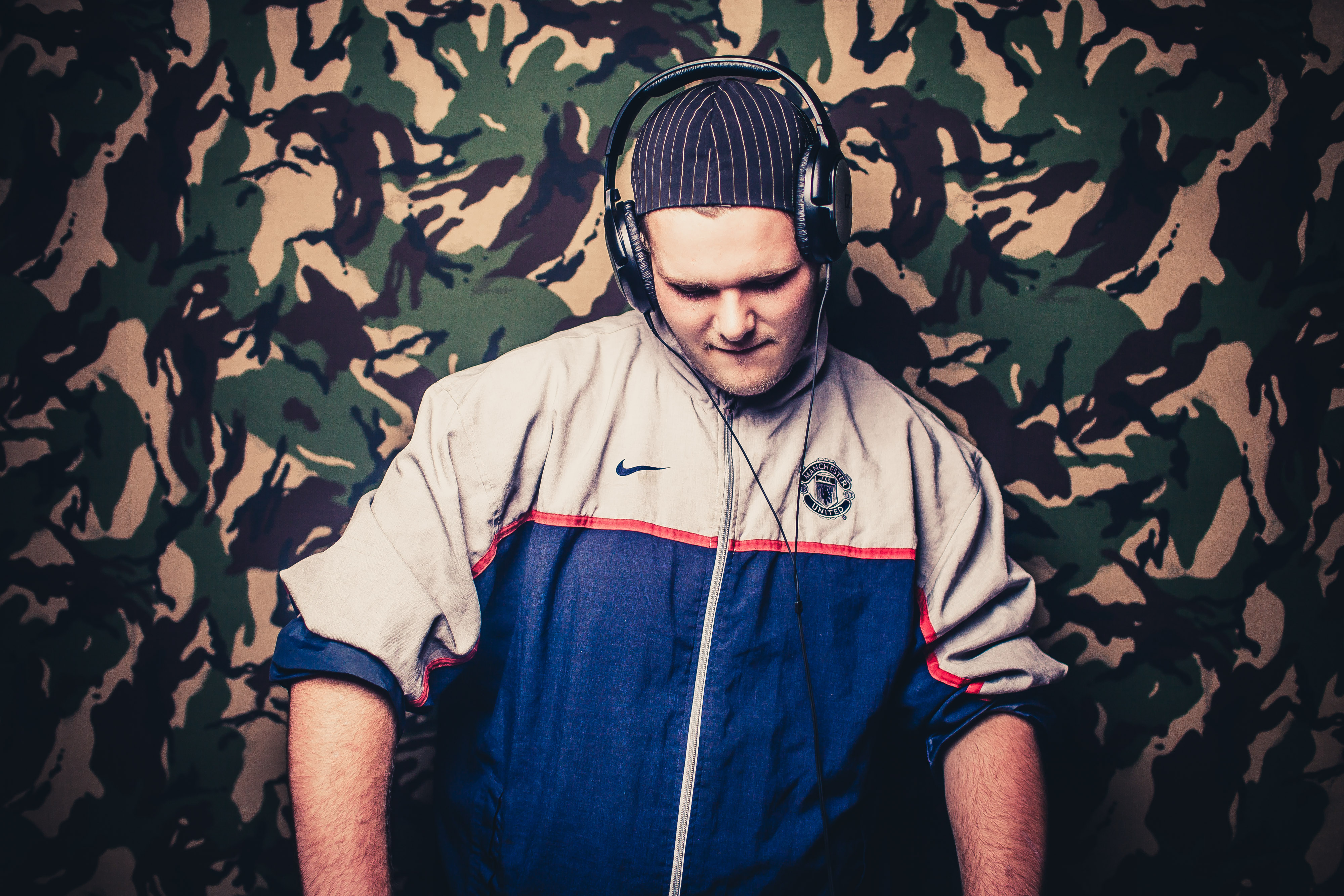 Young man wearing headphones using a mixing desk at Band Room