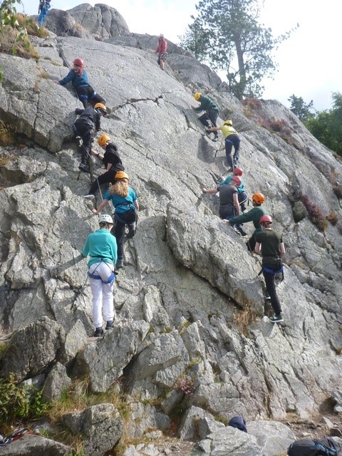 Young people climbing a rock face in Wales on a Pie Factory Music residential activity trip to Arete Outdoor Centre.