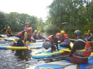Young people kayaking in Wales on a Pie Factory Music residential activity trip to Arete Outdoor Centre.