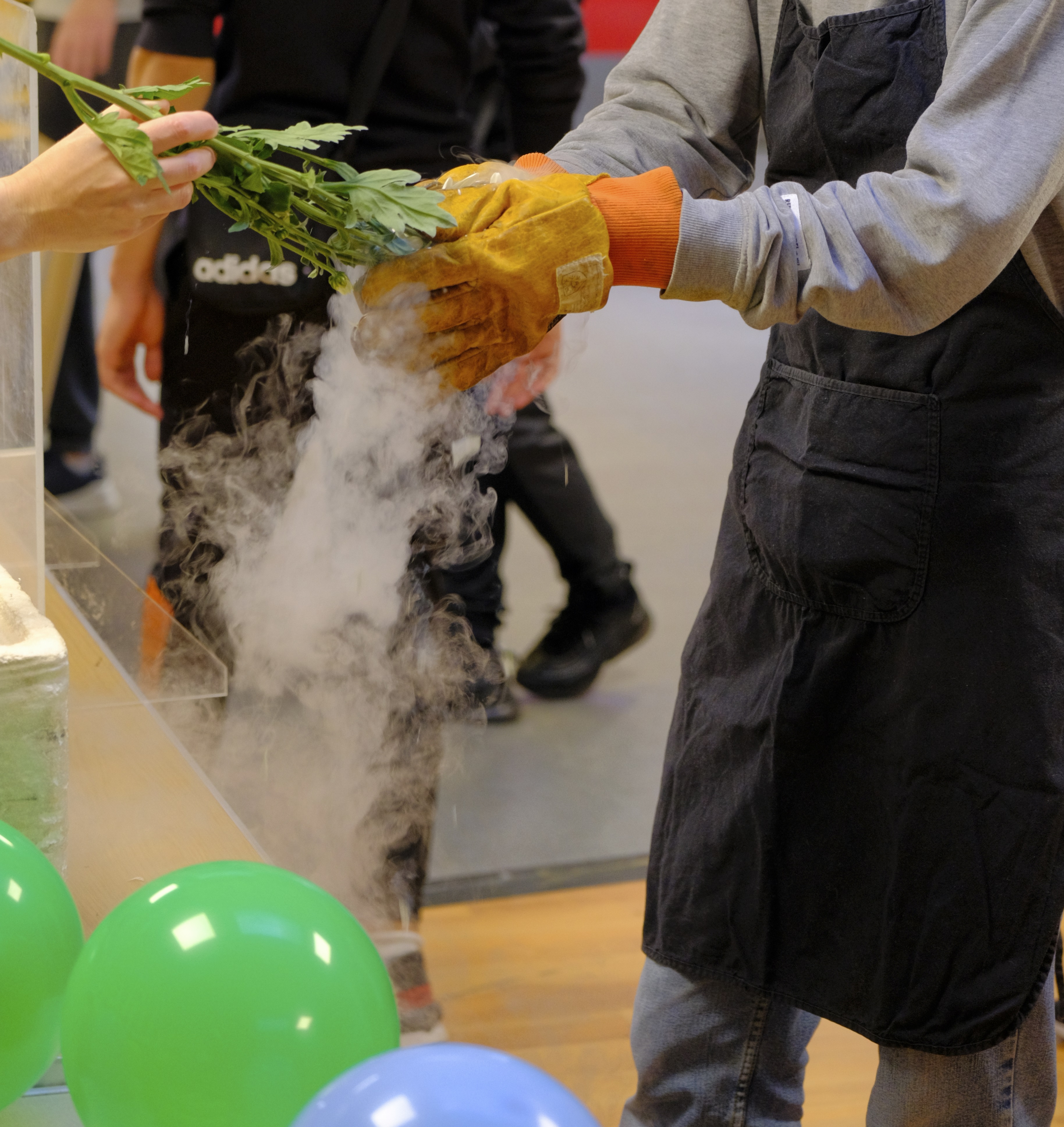 Young person taking part in a science experiment with steam as part of Open Arms session
