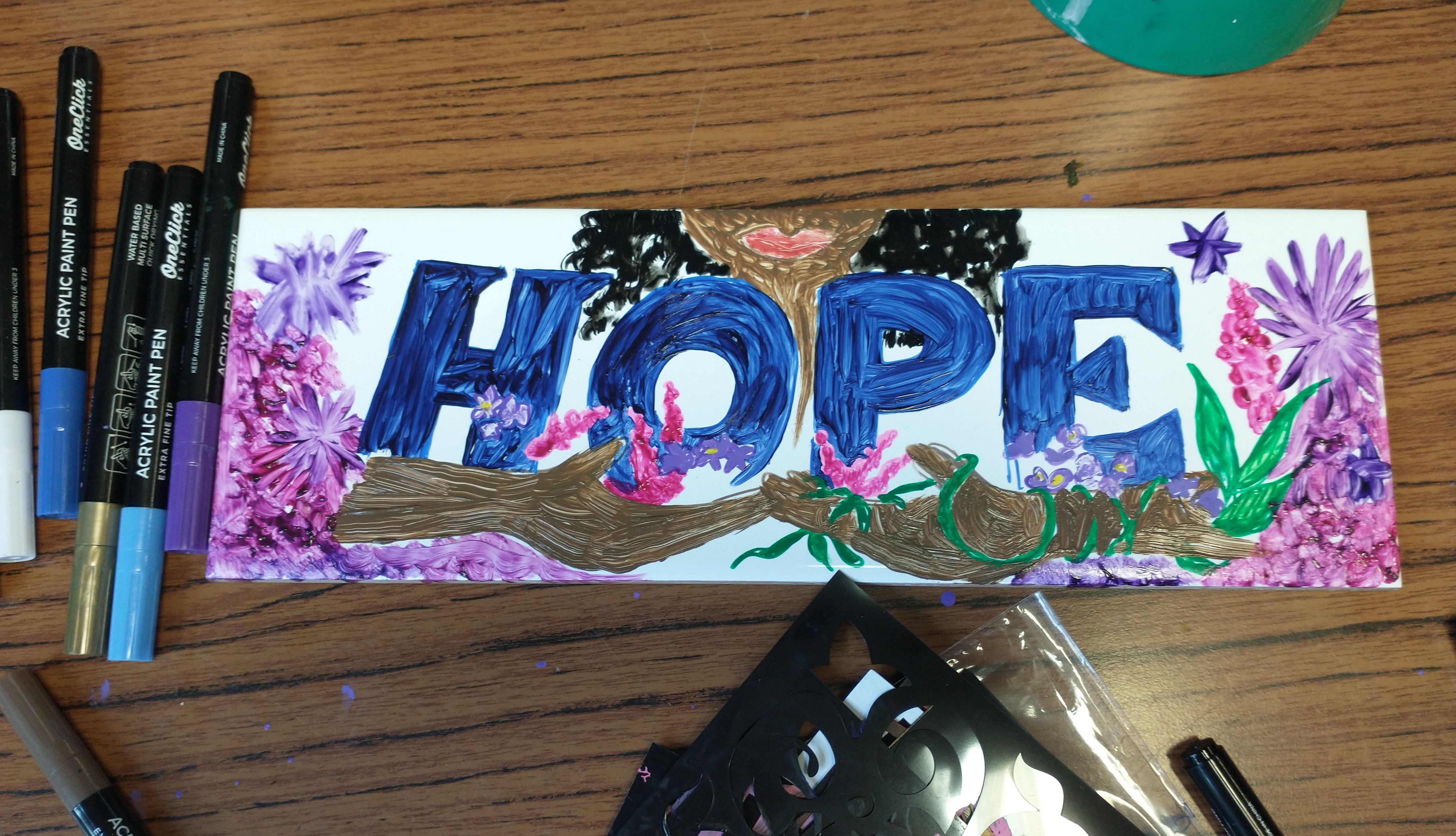 A artwork banner with the word 'Hope' written on it, created by young people from Pie's Open Arms sessions